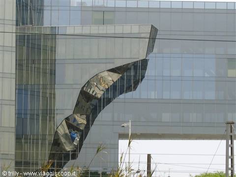 Curved reflective glass facade on modern building, soft grey daylight