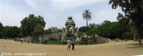 Tourists stroll in front of the monumental Cascada fountain in Barcelona