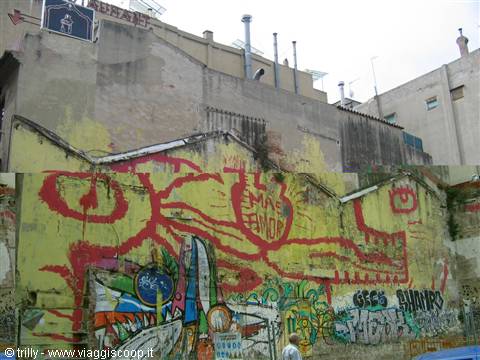 Weathered walls covered in red and yellow graffiti, a passerby walks below