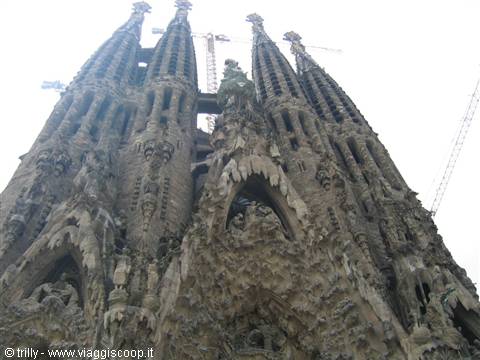 Sculpted facade of the Sagrada Família in Barcelona, stone towers against the sky