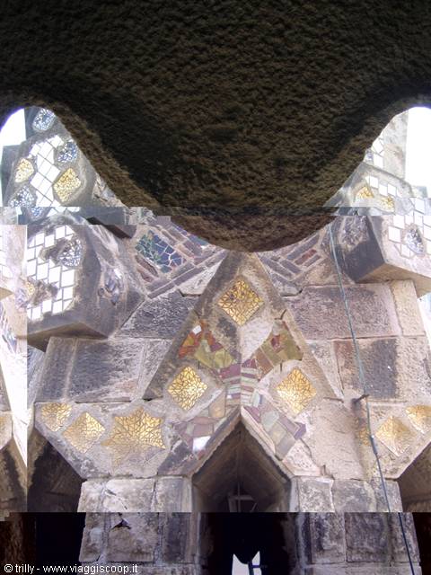 Gaudí's Sagrada Família tower, stone and golden mosaics from below