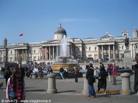 Crowds around the fountain in Trafalgar Square facing the National Gallery, London