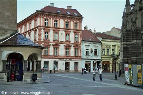 Tourists walk across the square in front of the Seidel Palace, Kutná Hora