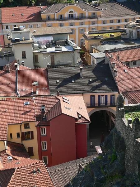 Red rooftops and colorful houses of Bellinzona seen from the castle walls