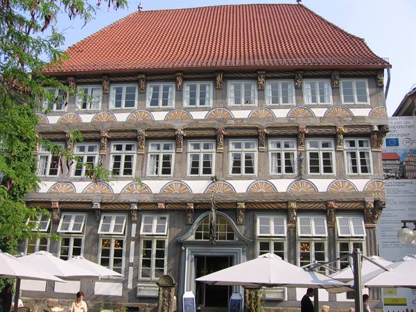 Ornate half-timbered house with café umbrellas in front of entrance