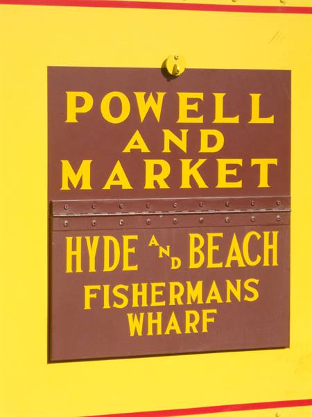 Brown metal cable car destination sign, Powell and Market, Fisherman's Wharf