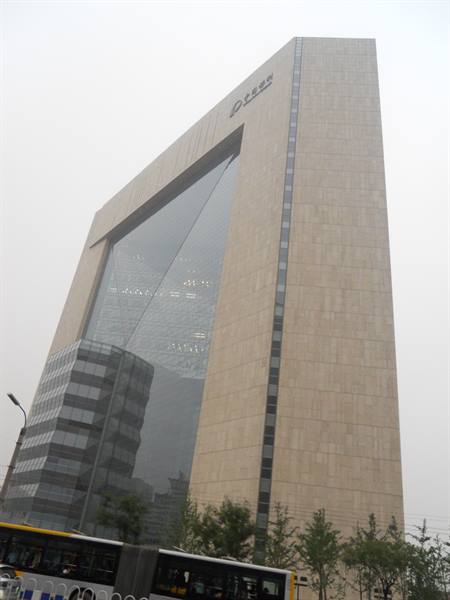 The Gate of the Orient, arched stone and glass skyscraper in fog