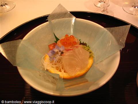 Kaiseki dish with sashimi, fish roe and edible flowers on rice paper
