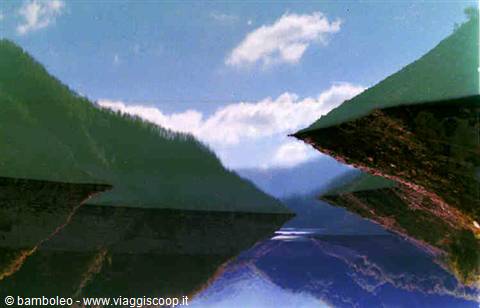 Mountains reflected in still water create an upside-down illusion