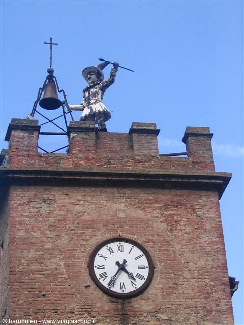 Metal figure strikes the bell atop a brick clock tower