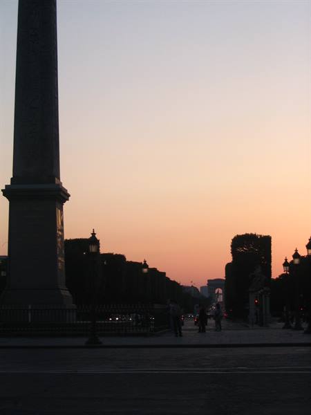 Obelisk silhouetted at Place de la Concorde, facing the Arc de Triomphe