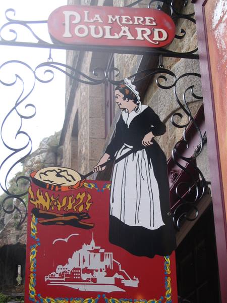 Wrought iron La Mère Poulard sign at Le Mont-Saint-Michel, woman cooking crêpes