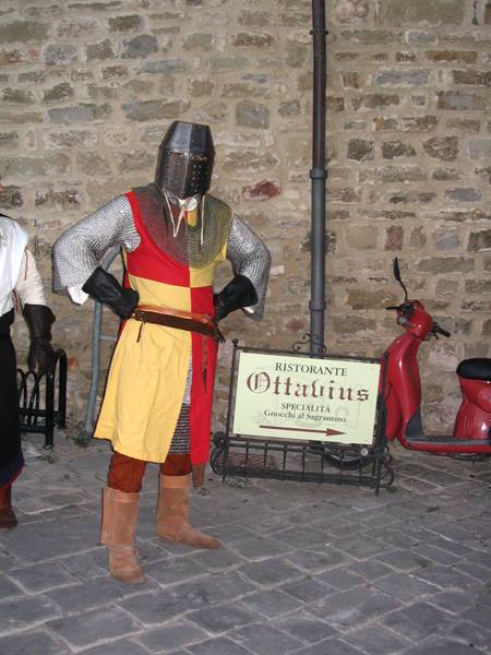 Knight in helmet and chainmail beside the Ottavius restaurant sign