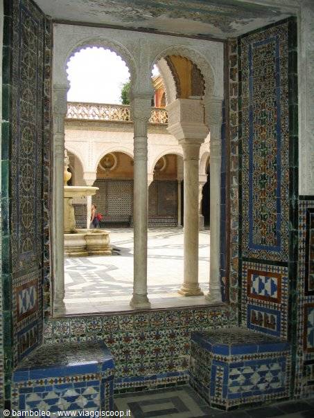 Marble arches and azulejos in Seville's Casa de Pilatos, courtyard with fountain