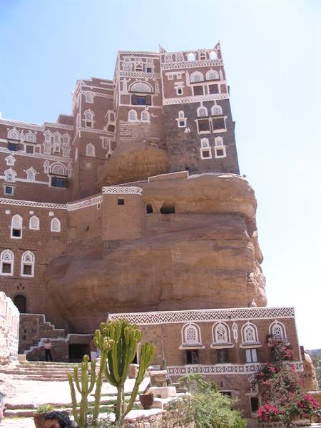 Dar al-Hajar palace built atop a rock at Wadi Dhahr, with cacti