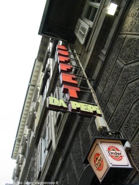 Lit sign of Buffet da Pepi on stone facade, Dreher lantern