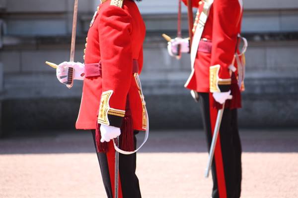 Royal guards in red uniforms with gold sword and white gloves