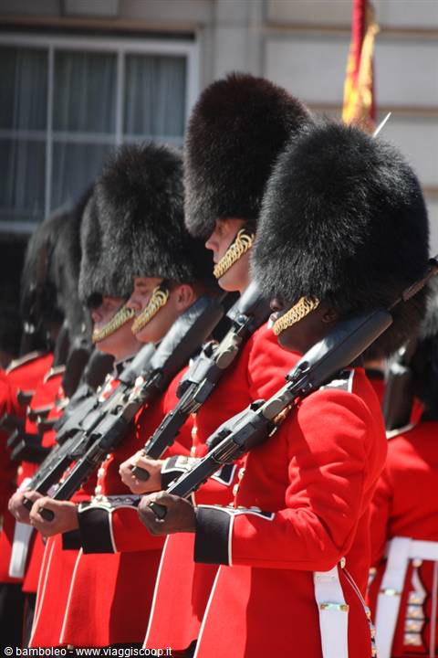 Royal guards in red uniforms and black bearskin caps with rifles, London