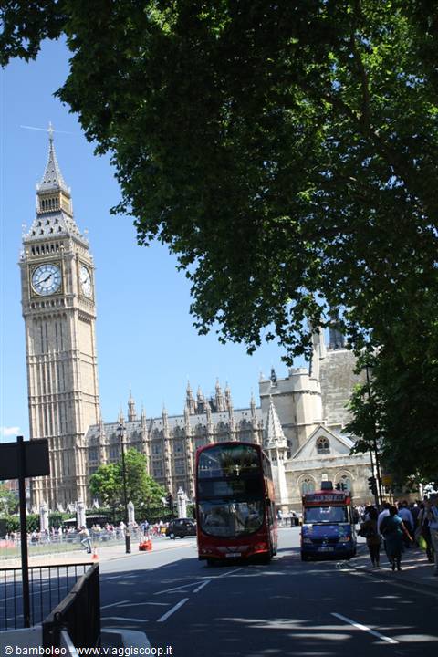 Red double-decker buses passing Big Ben in London