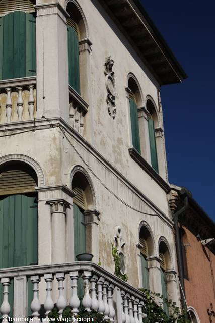 Venetian palace with green shutters, Istrian stone balustrade and blue sky