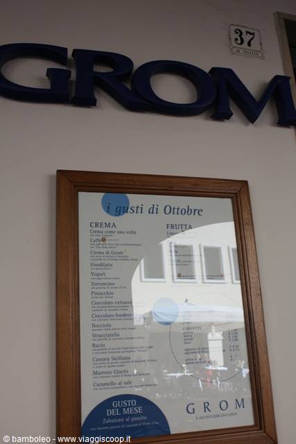 Blue GROM sign and wooden-framed October flavor menu on wall