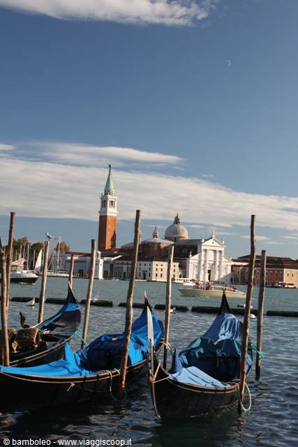 Blue-covered gondolas moored in Venice, San Giorgio Maggiore in the background