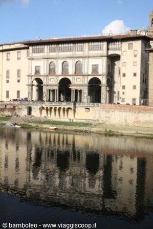 Uffizi Gallery facade with arches reflected in the Arno, Florence
