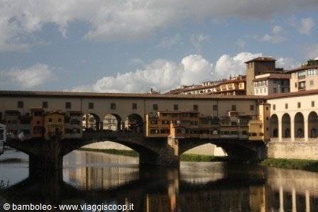 Ponte Vecchio with shops over the Arno in Florence, reflections in the water