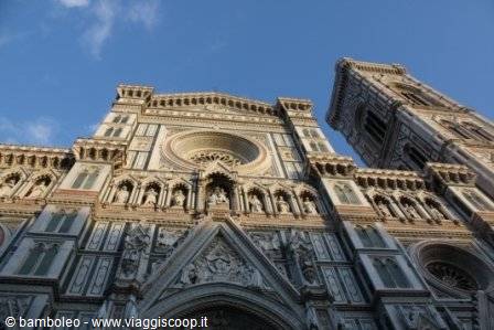 Marble facade of Florence Cathedral with Giotto's bell tower under blue sky