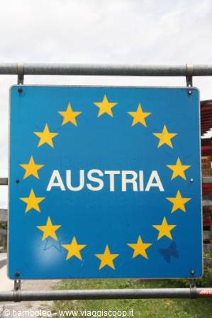 Blue European Union sign with yellow stars marks the Austrian border