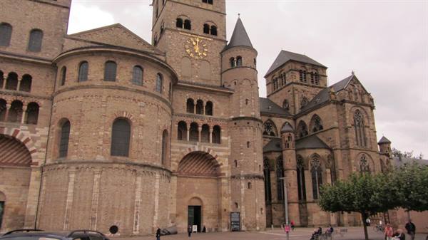 Romanesque stone cathedral in Trier with round apse and towers