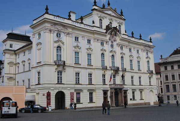 Baroque Archbishop's Palace in Hradčany Square, Prague, under blue sky