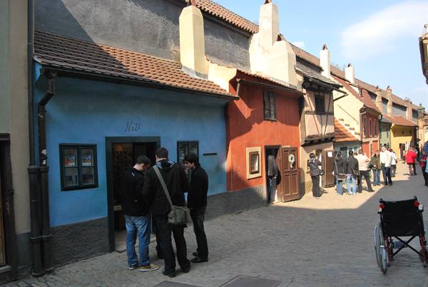 Tourists outside the colorful houses of Golden Lane, Prague