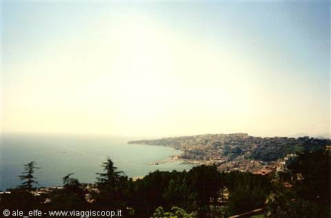 Coastal town overlooking the blue sea under a hazy sun