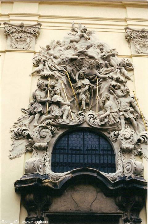 Baroque stone sculptures with angels and saints above a church window