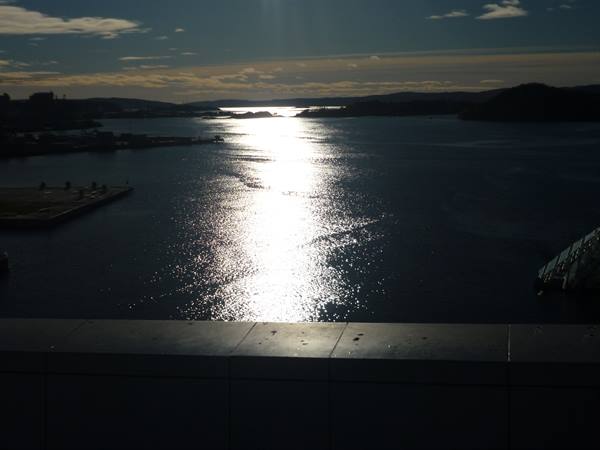 From the Oslo Opera House roof, sunlight reflects on the fjord