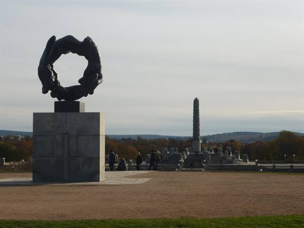 Vigeland Park, Oslo: bronze wheel sculpture and monolith among visitors