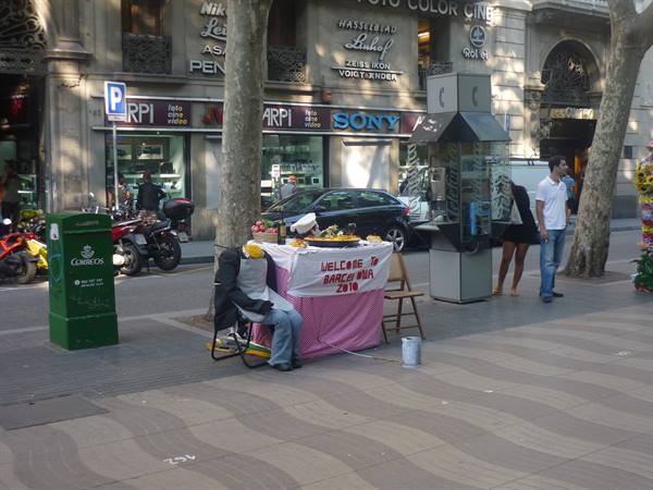 Las Ramblas, Barcelona, seated dummy in front of a pink-clothed street stall