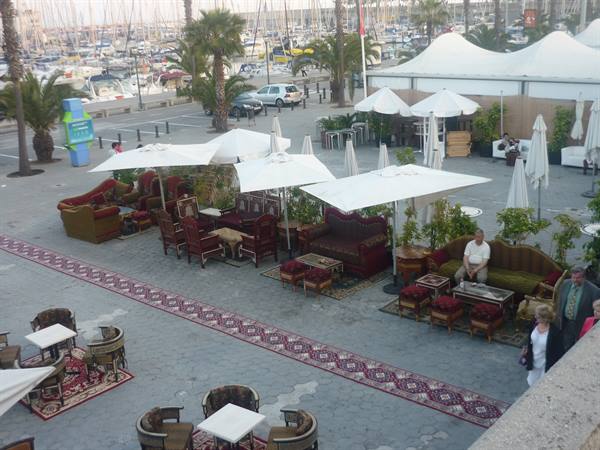 Oriental sofas under white parasols beside the Ocean Village marina, Gibraltar
