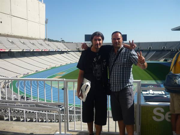 Two tourists pose by the blue track at Estadi Olímpic Lluís Companys, Barcelona