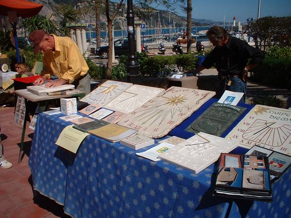 Craftsman displaying stone sundials at the harbor market in Menton