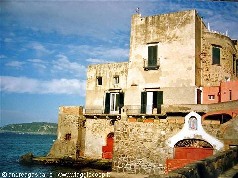 Old ochre houses overlooking the sea at Ischia Ponte, midday light