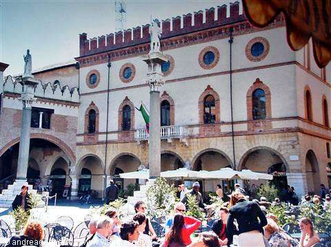 Tourists at outdoor cafe tables in front of the town hall, Padua
