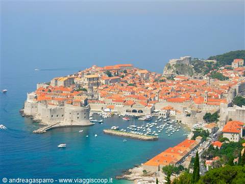 Dubrovnik old town: walls, red rooftops and harbour with boats on the Adriatic