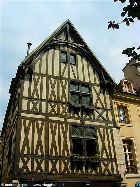 Medieval half-timbered house with crossed wooden beams and leaded windows