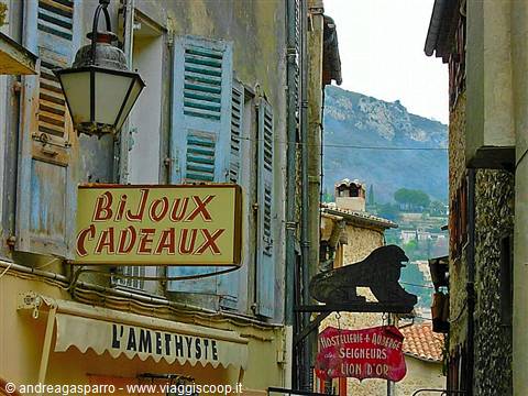Alley with Bijoux Cadeaux sign, blue shutters, lantern and mountain in the background