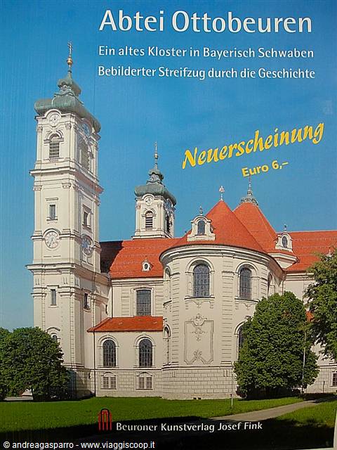 Ottobeuren Abbey, white baroque facade with tower and red roofs under blue sky