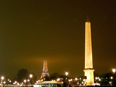 Illuminated obelisk at night on Place de la Concorde, Eiffel Tower glowing behind