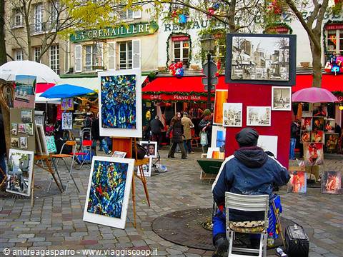 Painter at easel on Place du Tertre, canvases and umbrellas