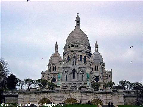 The Sacré-Coeur Basilica in Paris, white domes under a cloudy sky